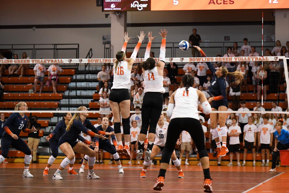 Bowling Green, OH - Falcons fifth year senior Alexis Mettille (16) and junior opposite Lauryn Hovey (14) setting a block to stop the Illini attack at Stroh Center in Bowling Green, Ohio.