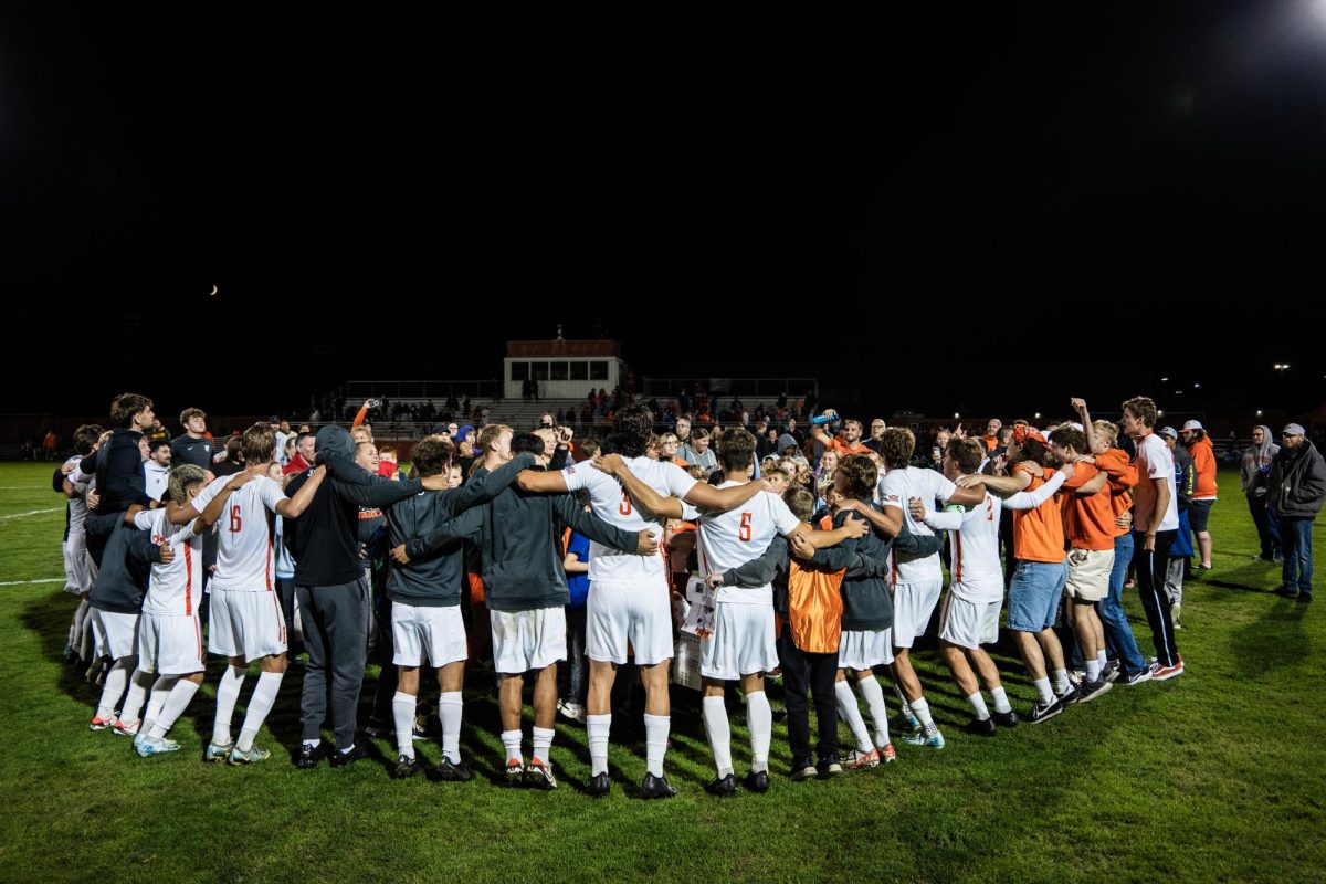 Bowling Green, OH – Falcons huddle with fans to celebrate at the conclusion of the game by chanting Ay Ziggy Zoomba at Cochrane Field in Bowling Green, Ohio