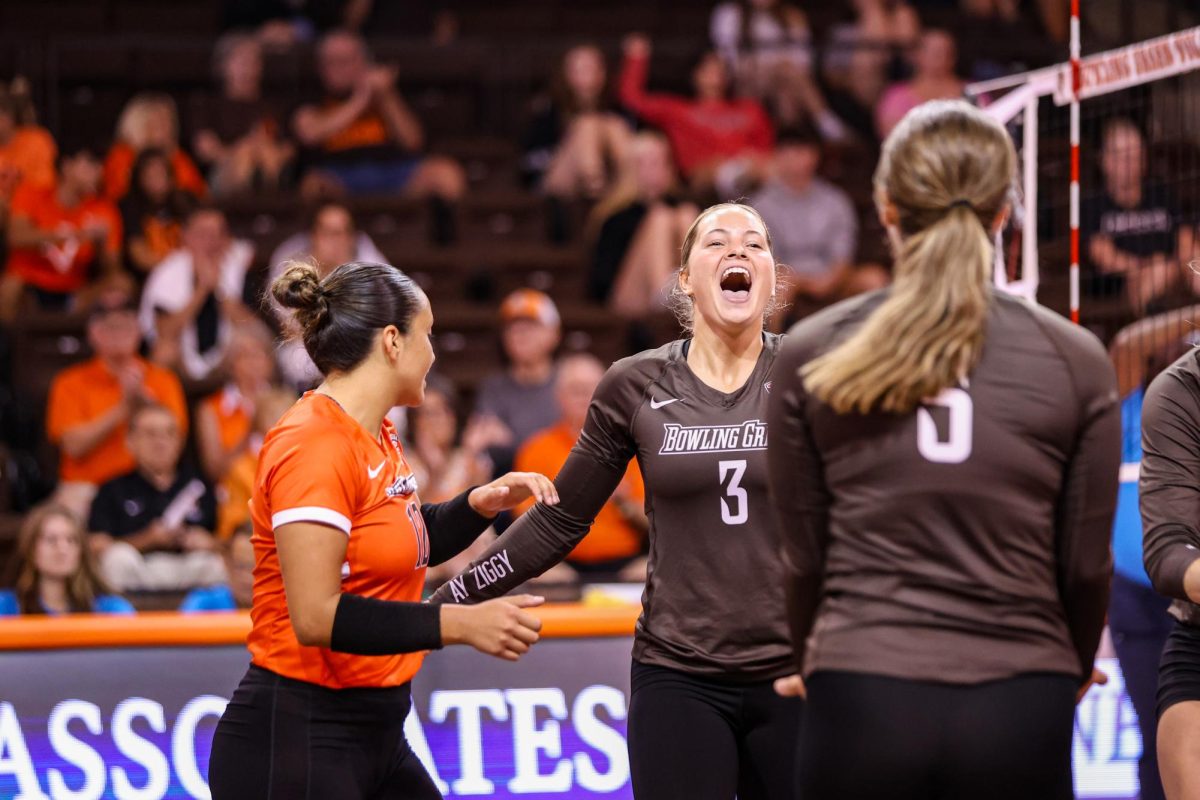 Bowling Green, OH - Falcons freshman defensive specialist Avery Anders (3) celebrates with graduate
student libero Lindsey LaPinta (12) and freshman setter Anna Sitek (5) during a game against the Cincinnati Bearcats at the Stroh Center in Bowling Green, Ohio.
