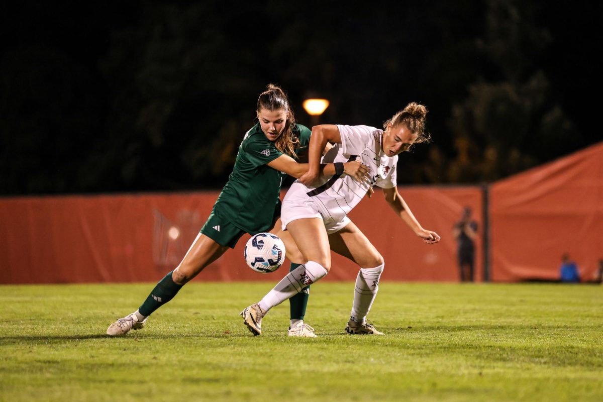 Bowling Green, OH - Falcons Sophomore forward Lexi White (21) fights an Ohio University defender for the ball at Cochrane Stadium in Bowling Green, Ohio.