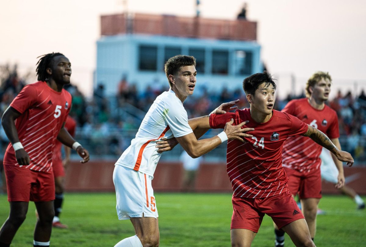 Bowling Green OH - Falcons sixth year defender Josh Erlandson (5) going up against a Husky defender during a Falcon corner kick at Cochrane Stadium in Bowling Green, Ohio.