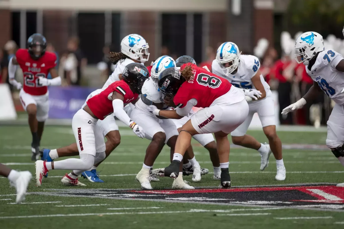 NIU #8 defensive tackle Devonte O'Malley takes a hit. 