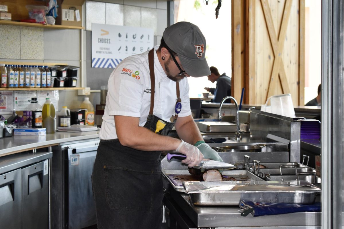 A chef at the Social House at the Oaks preparing food for students