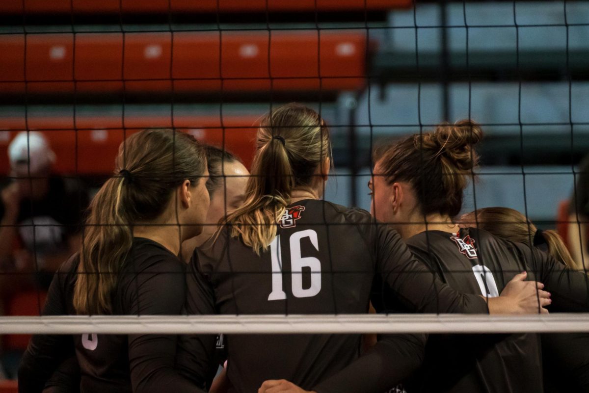 Bowling Green, OH - Falcons players huddle briefly after a lost point at the Stroh Center in Bowling Green, Ohio.