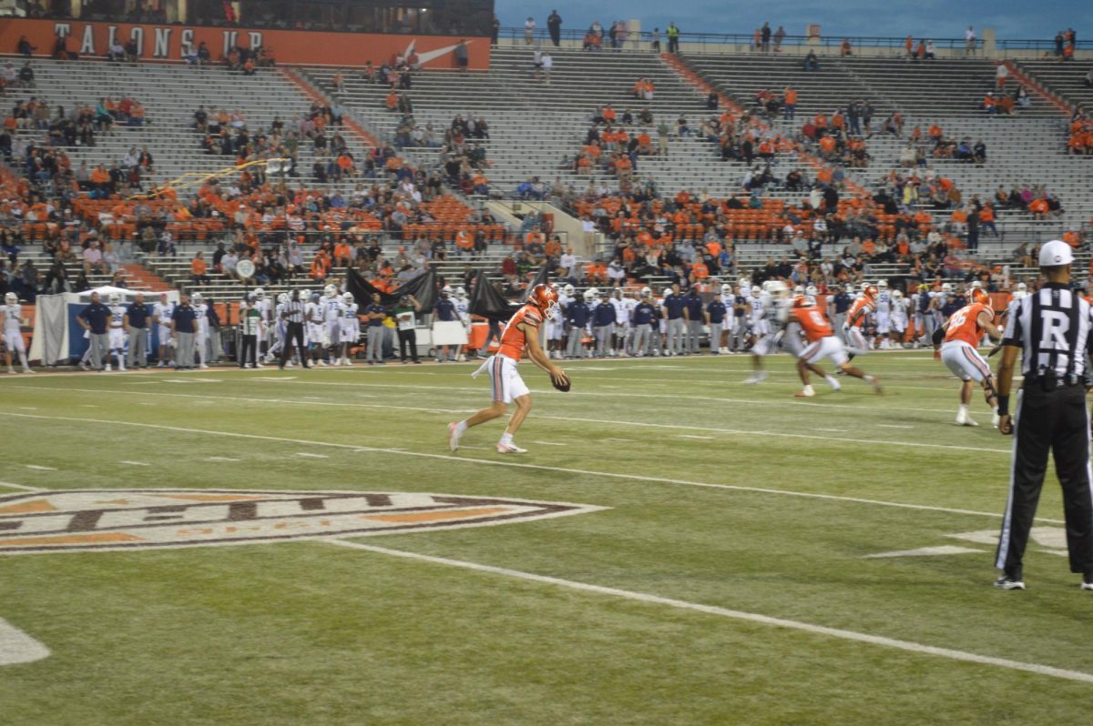 Bowling Green, OH - Falcons sophomore kicker Jackson Kleather (14) punting to the Monarchs at Doyt L. Perry Stadium in Bowling Green, Ohio.