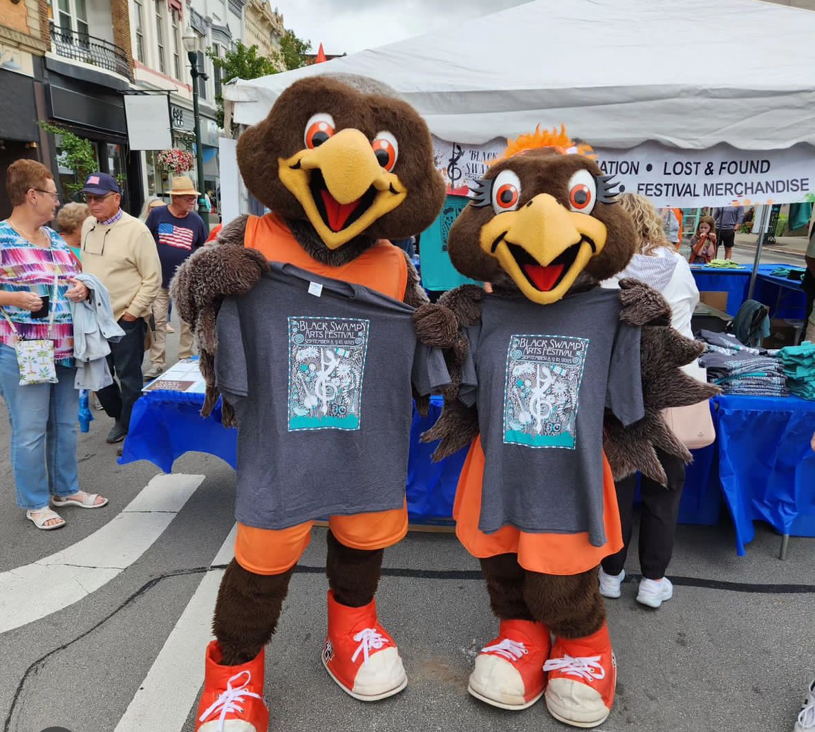 Freddie and Frieda Falcon, BGSU's mascots, pose with Black Swamp t-shirts