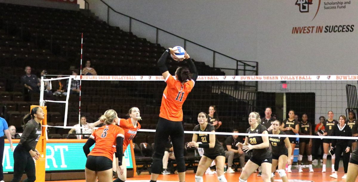 Bowling Green, OH- Falcons sophomore setter Amanda Otten (11) sets the ball for 5th year Middle Blocker Alexis Mettille (16) at the Stroh center in Bowing Green, Ohio.