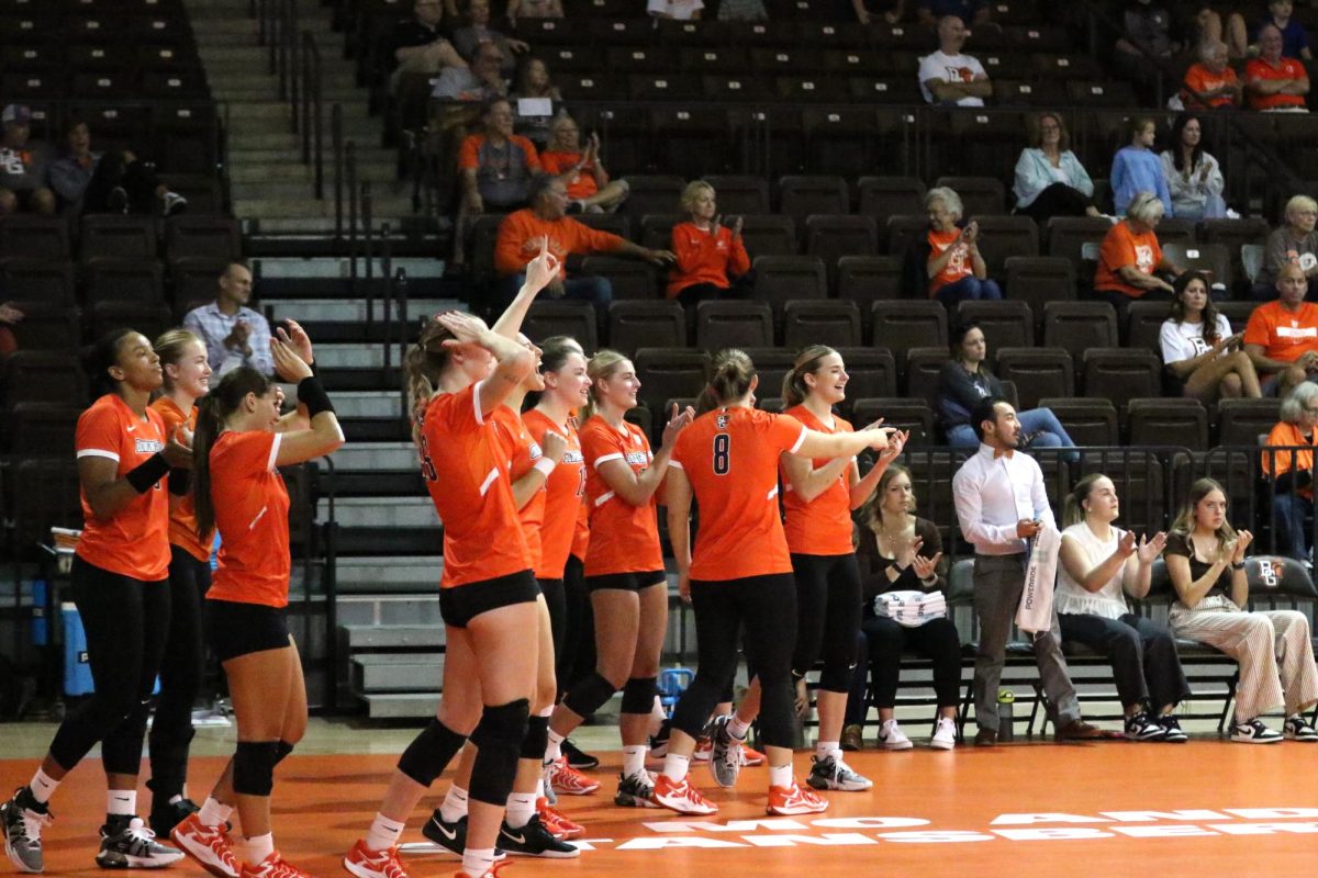 Bowling Green, OH - Falcons bench celebrates after junior opposite Lauryn Hovey (14) sets the record for Aces in Bowling Green