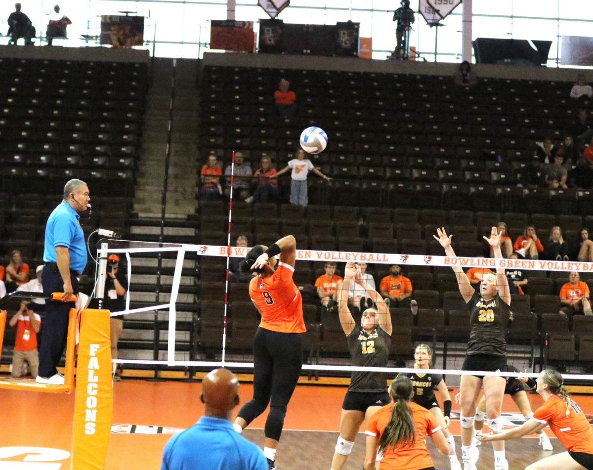 Bowling Green, OH - Falcons senior Outside Hitter Mia Tyler (9) goes for a kill at the Stroh Center in Bowling Green, Ohio.