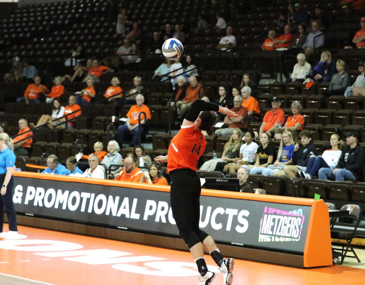 Bowling Green, OH- Junior Opposite Hitter Lauryn Hovey (14) goes for a serve after a point at the Stroh Center in Bowling Green, Ohio.