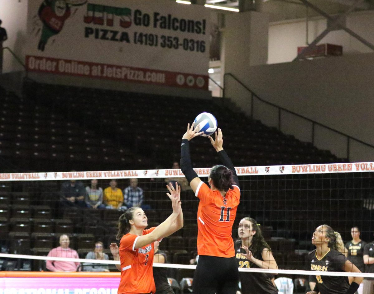 Bowling Green, OH- Sophomore Right Side Setter Amanda Otten (11) and Junior Middle Blocker jessica Andrews (7) go up for a quick play against Western Michigan at the Stroh Center in Bowling Green, Ohio.