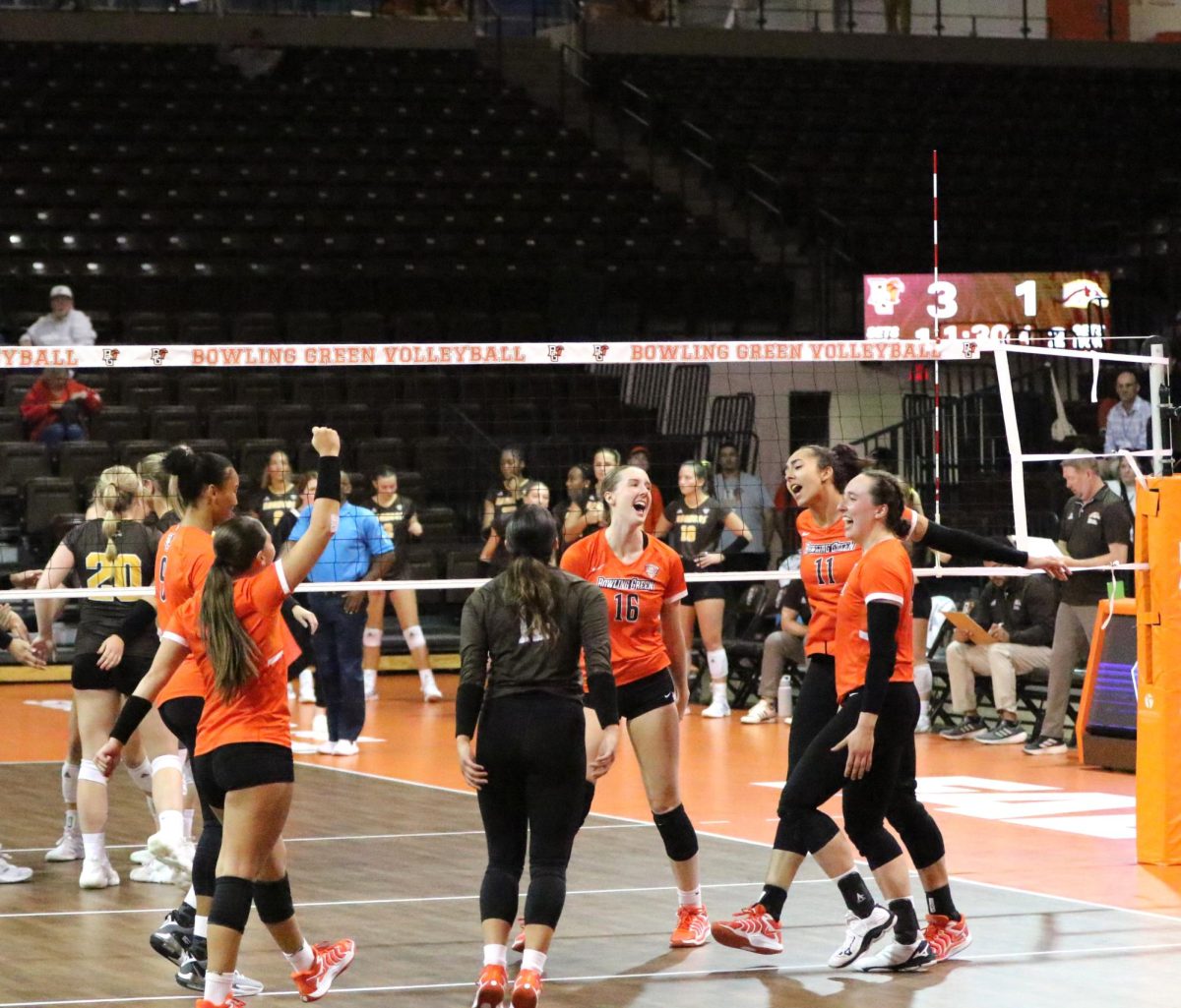 Bowling Green, OH- The team celebrates after Sophomore Setter Amanda Otten (11) scores a point in the third set at the Stroh Center in Bowling Green, Ohio.