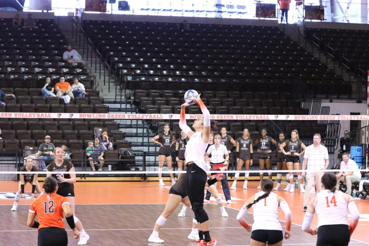 Bowling Green, OH - Sophomore Setter Amanda Otten (11) goes high for a set against Western Michigan at the Stroh Center in Bowling Green, Ohio.