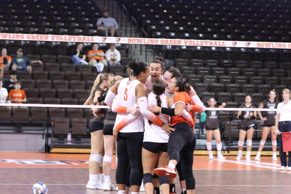 Bowling Green, OH - The team hugs and celebrates after Junior Opposite Hitter Lauryn Hovey (14) scores another point for BGSU at the Stroh Center in Bowling Green, Ohio.