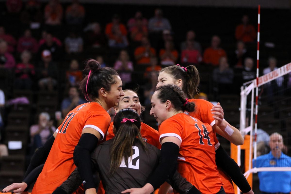 Bowling Green, OH - Falcons celebrates together after a late point in the first set against at Stroh Center in Bowling Green, Ohio.