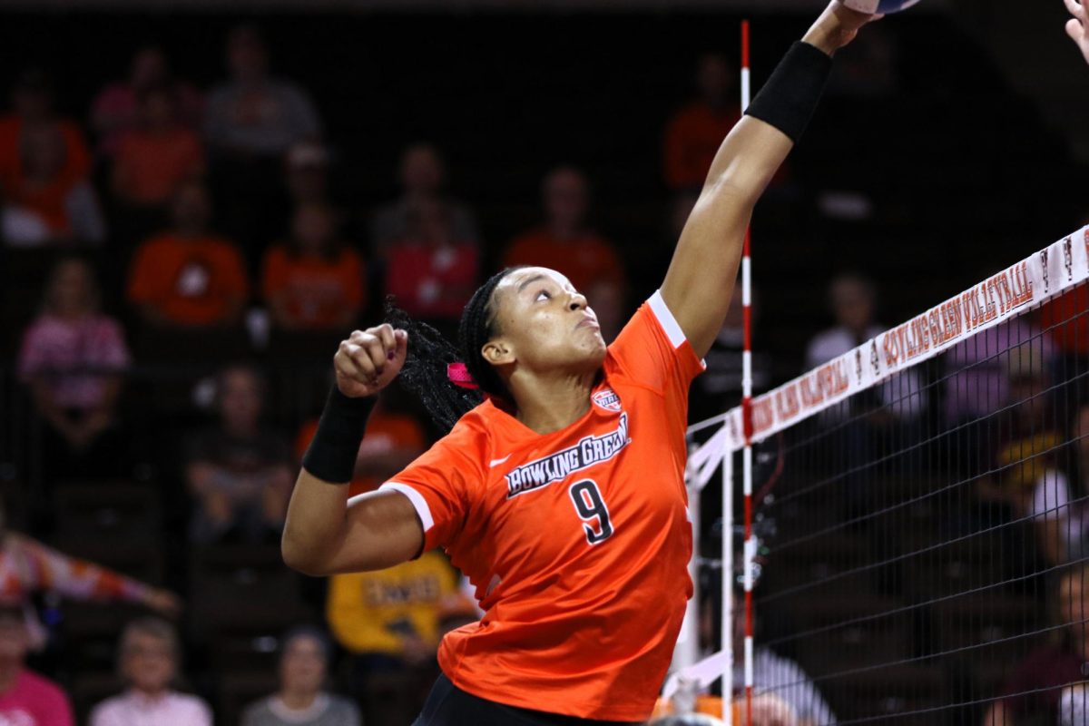 Bowling Green, OH - Falcons Senior Outside Hitter Mia Tyler (9) makes a great move on the ball for a point at Stroh Center in Bowling Green, Ohio.