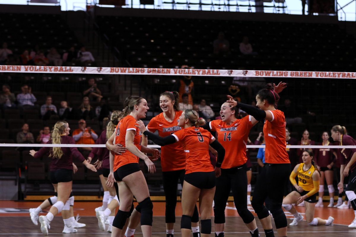 Bowling Green, OH - Falcons celebrate together after taking a big lead in the second set against the Chippewas at Stroh Center in Bowling Green, Ohio.