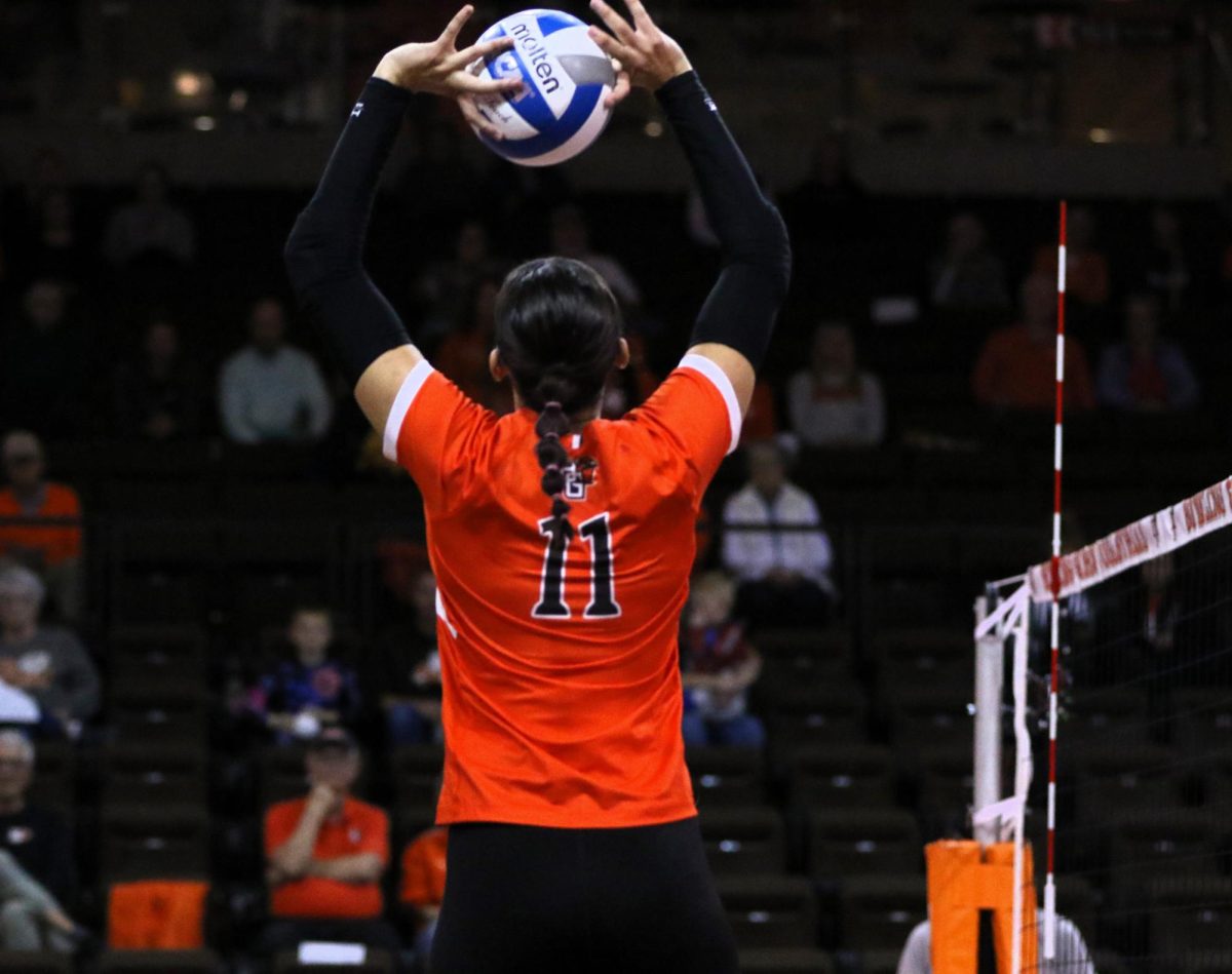 Bowling Green, Ohio - Falcons sophomore setter Amanda Otten (11) setting the ball during their win against the Golden Flashes at Stroh Center in Bowling Green, Ohio.