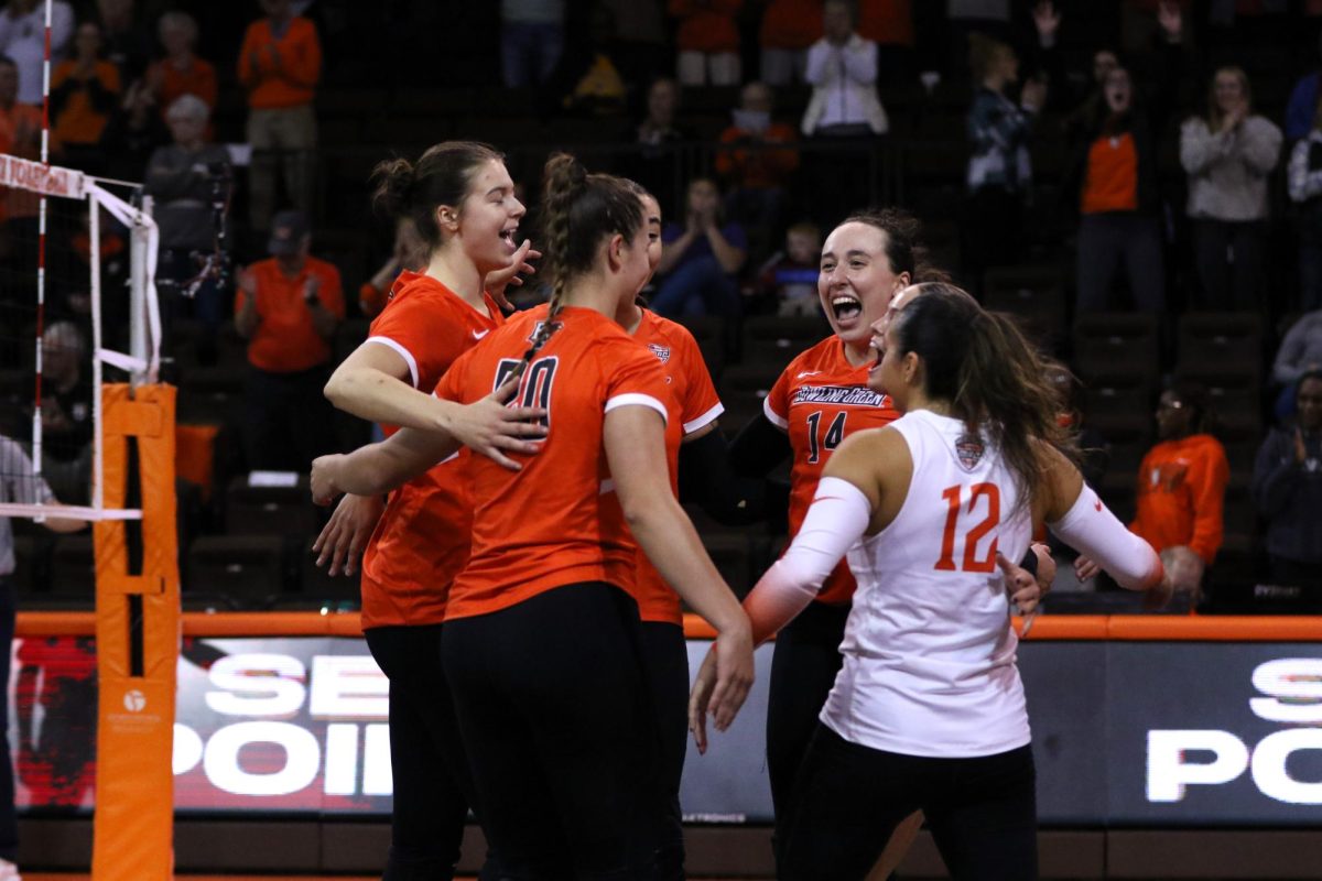 Bowling Green, OH - Falcons  celebrate a point after a point late into the second set against the Golden Flashes at Stroh Center in Bowling Green, Ohio.