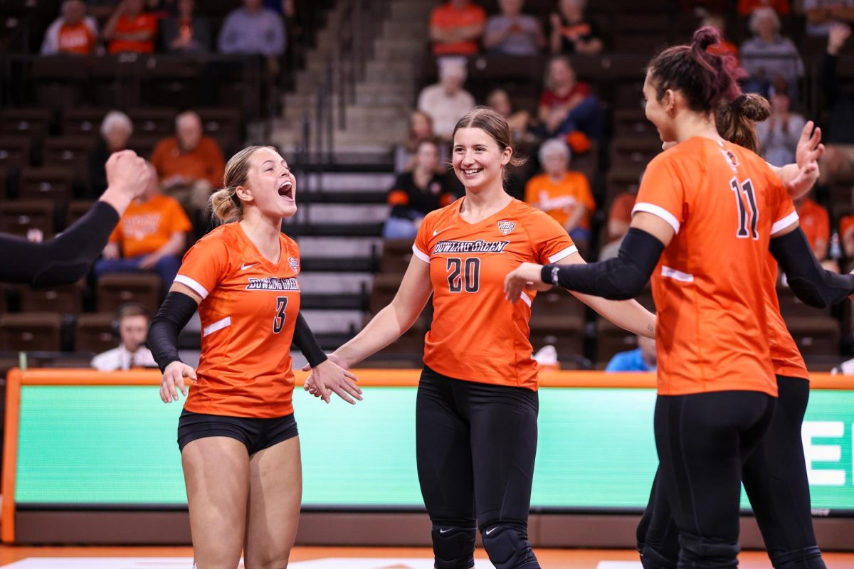 Bowling Green, OH - Freshman defensive specialist Avery Anders (3) and redshirt freshman outside hitter Edyta Waclawczyk (20) celebrate after scoring a point against Western Michigan at the Stroh Center in Bowling Green, Ohio.