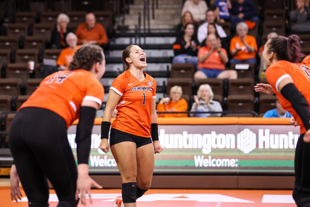 Bowling Green, OH - Freshman defensive specialist Sydnie Hernandez (1) celebrates following a point scored in a match against Western Michigan.