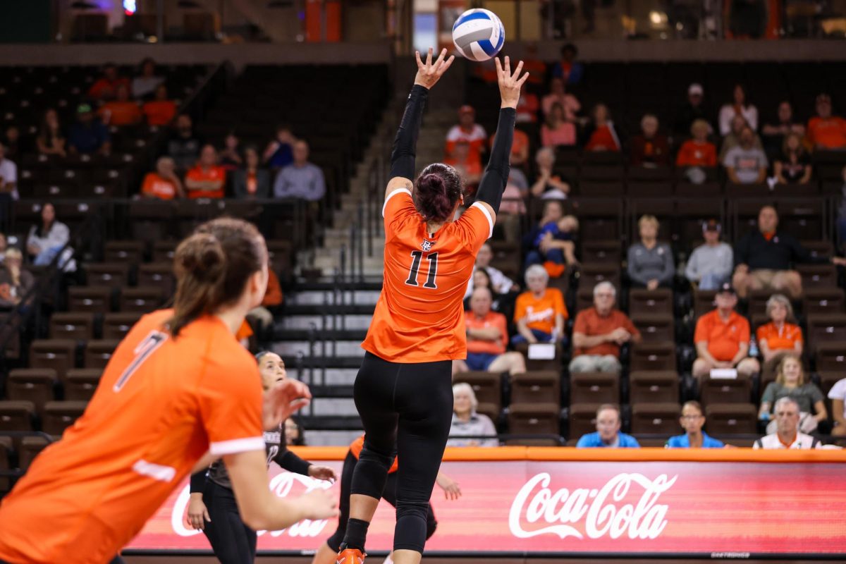 Bowling Green, OH - Right side setter sophomore Amanda Otten (11) sets the ball at the Stroh Center in Bowling Green, Ohio.