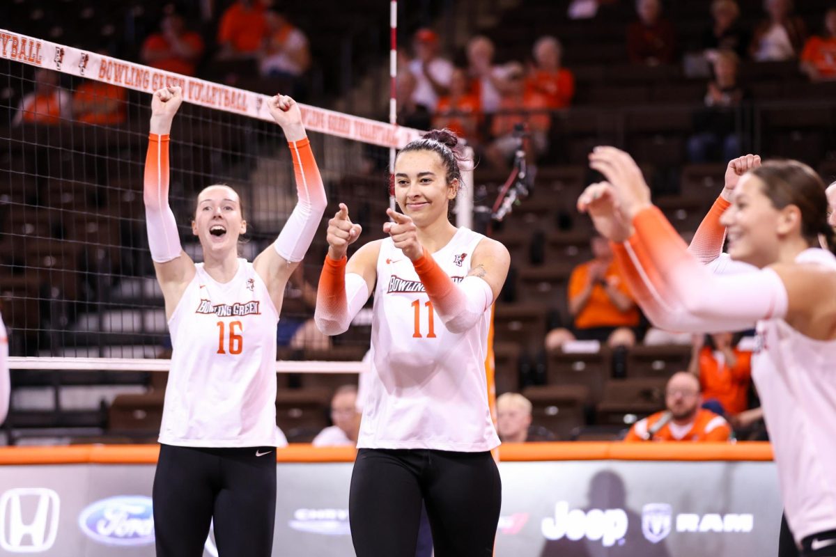 Bowling Green, OH - Falcons Sophomore setter Amanda Otten (11) points at senior outside hitter Mia Tyler (9) after scoring a kill against Western Michigan in the Stroh Center in Bowling Green, Ohio.