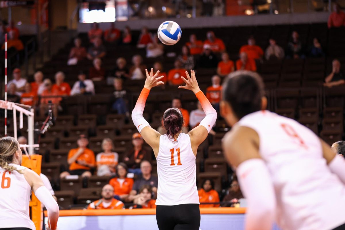 Bowling Green, OH - Falcons Sophomore setter Amanda Otten (11) sets the ball in a matchup against the Broncos of Western Michigan at the Stroh Center in Bowling Green, Ohio.