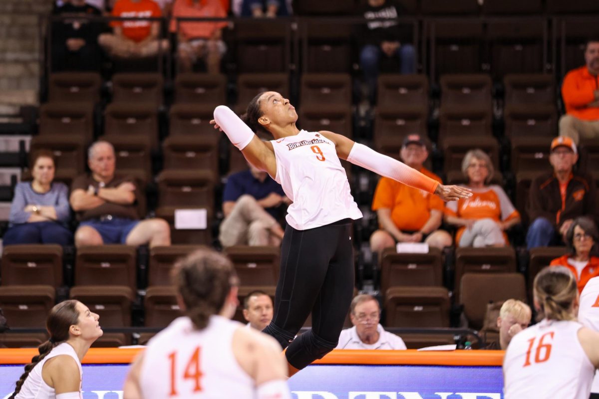 Bowling Green, OH - Falcons Senior outside hitter Mia Tyler (9) goes up to spike the ball against the Broncos of Western Michigan at the Stroh Center in Bowling Green, Ohio.