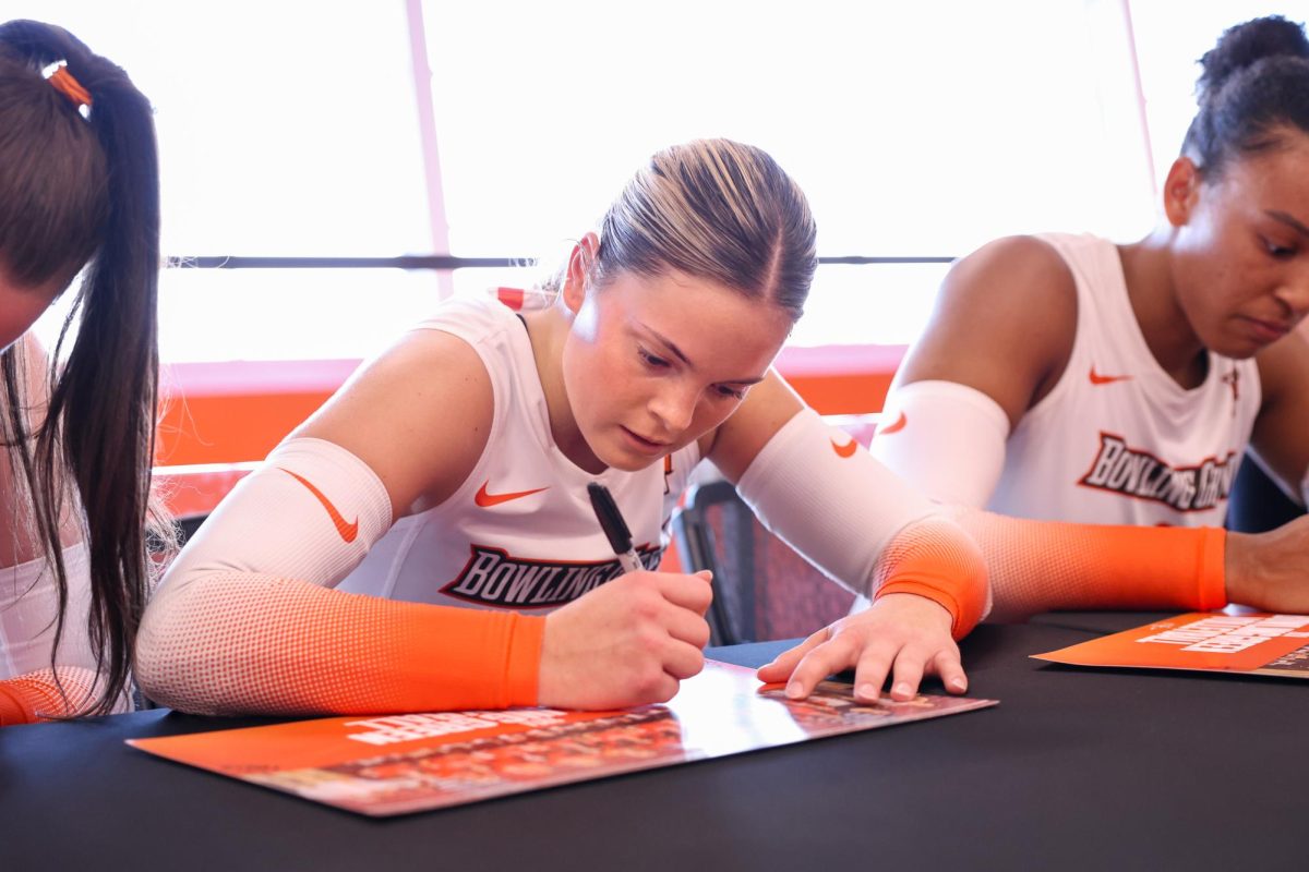 Bowling Green, OH - Falcons Freshman defensive specialist Avery Anders (3) signs a poster during an autograph signing event at the Stroh Center in Bowling Green, Ohio.