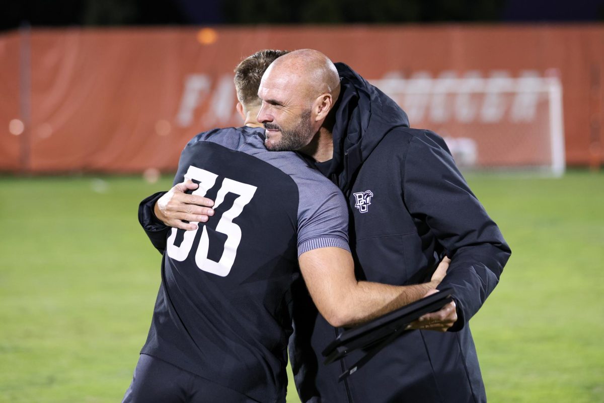 Bowling Green, OH - Falcons Fifth year goalkeeper Brendan Graves (33) hugs assistant coach Stu Riddle during senior night at Cochrane Stadium in Bowling Green, Ohio.