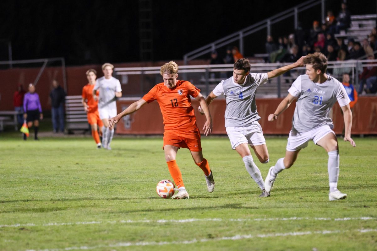 Bowling Green, OH - Falcons Sophomore forward Bennett Painter (12) kicks the ball towards the goal against the Bulldogs at Cochrane Stadium in Bowling Green, Ohio.