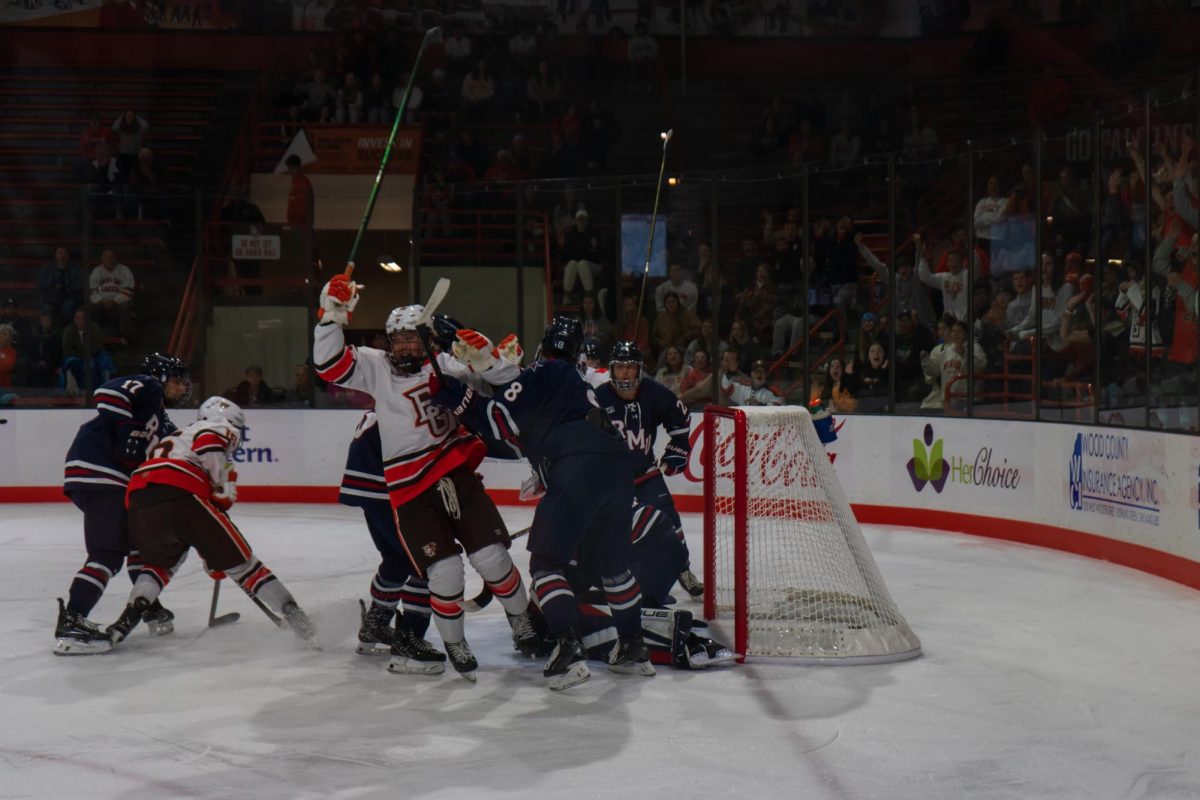 Bowling Green, OH - Falcons freshman forward Maxwell Martin (15) celebrates after scoring the Falcons first home goal of the season at Slater Family Ice Arena in Bowling Green, Ohio.