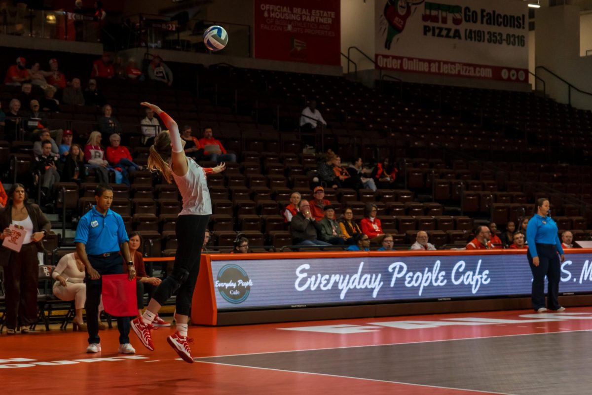 Bowling Green, OH - Falcons fifth year middle blocker Alexis Mettille (16) serves against the Golden Flashes at the Stroh Center in Bowling Green, Ohio.