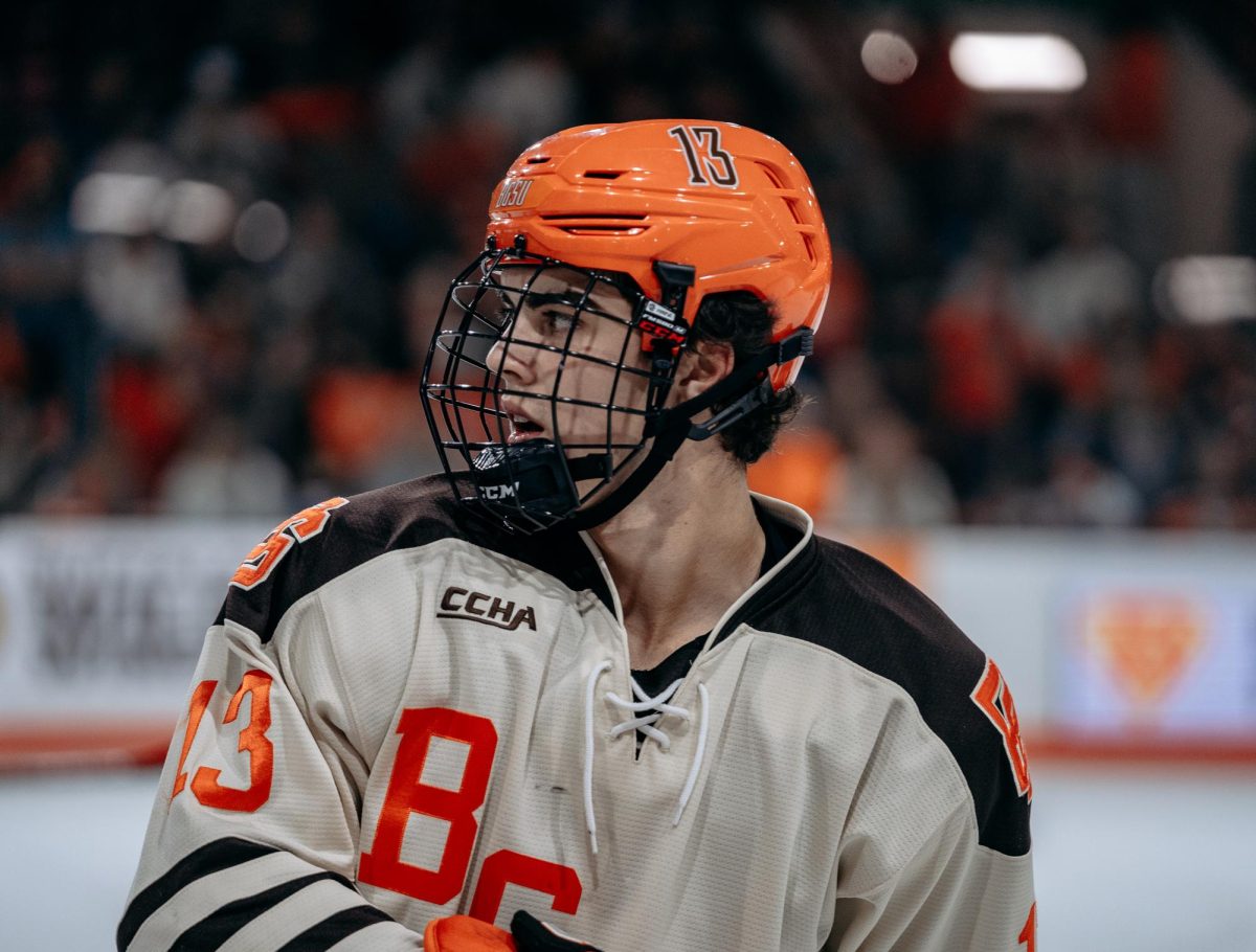 Bowling Green, OH – Falcons junior forward Brett Pfoh (13) awaits a face-off at Slater Family Ice Arena in Bowling Green, Ohio.