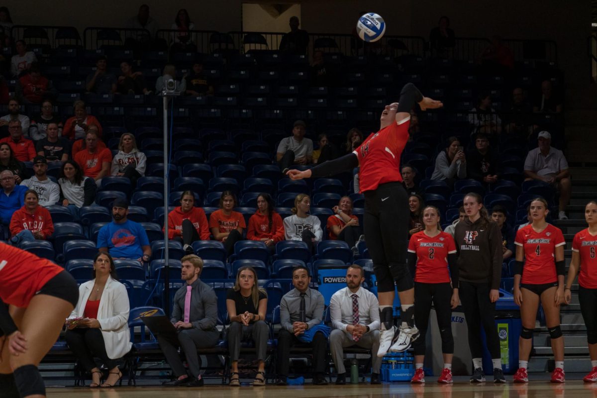 Toledo, OH - Falcons junior opposite Lauren Hovey (14) serving to the Rockets at Savage Arena in Toledo, Ohio.