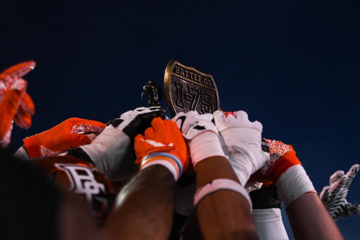 Toledo, OH - Falcons holding the Battle of I-75 trophy at the Glass Bowl in Toledo, Ohio.