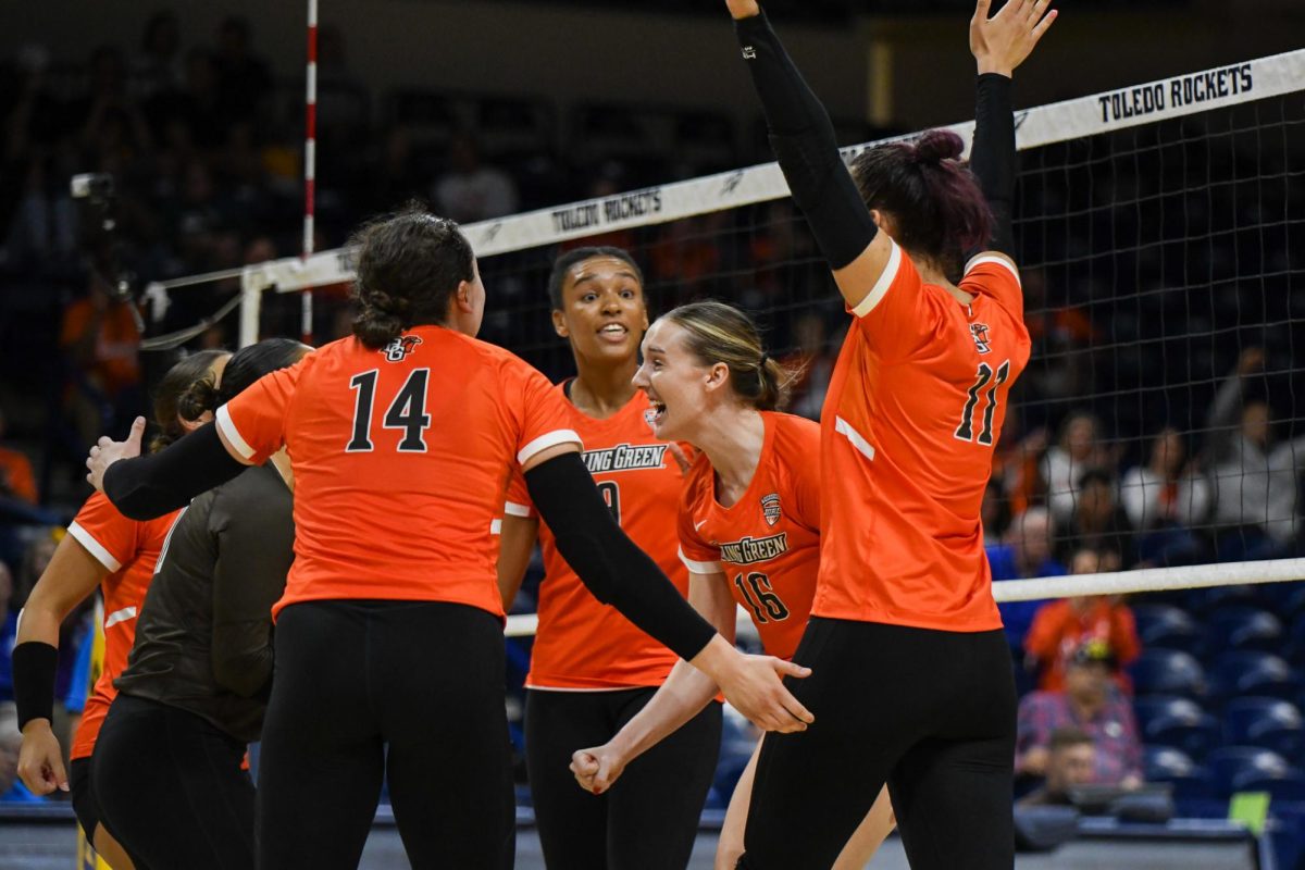 Toledo, OH - Falcons fifth year middle blocker Alexis Metille (16) celebrates blocking the Rockets attack at Savage Arena in Toledo, Ohio.