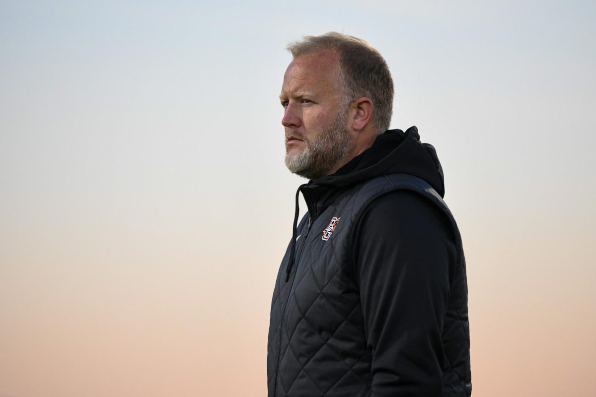 Bowling Green, OH - Falcons head coach Chris Fox watching his team warm up at Cochrane Stadium in Bowling Green, Ohio.