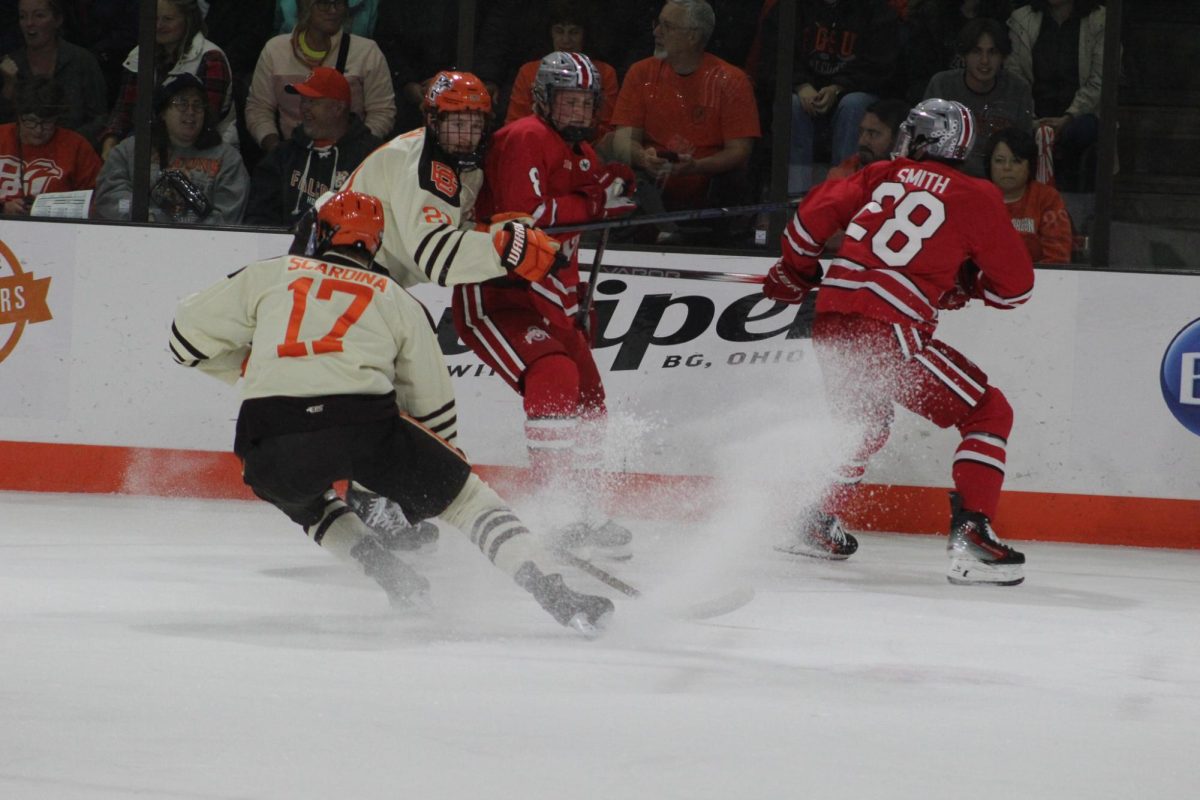 Bowling Green, OH - Falcons graduate forward Ethan Scardina (17) chasing the puck at Slater Family Ice Arena in Bowling Green, Ohio.