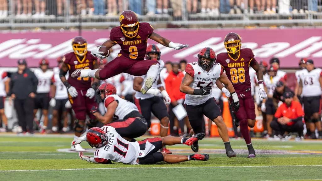 Marion Lukes of Central Michigan leaps over defender with the ball in tow. 