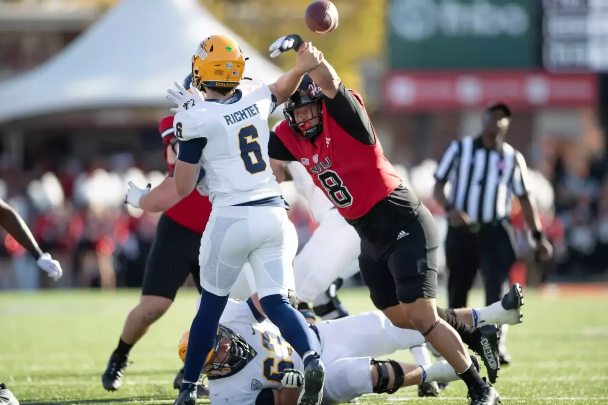 NIU's Devonte O'Malley attempts to block Toledo's John Alan Richter's throw. 