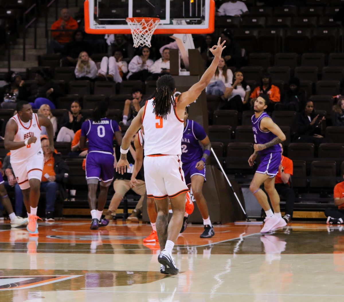 Bowling Green, OH - Falcons sophomore guard Braelon Green (5) celebrates after a teammate drains a three-point shot against the Purple Eagles in the Stroh Center in Bowling Green, Ohio.