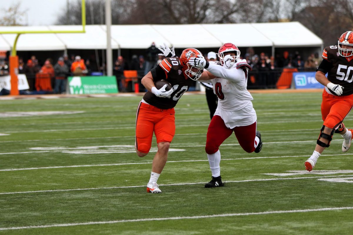 Bowling Green, OH - Falcons senior tight end Levi Gazarek (10) stiff arms a Miami Corner for a first down.