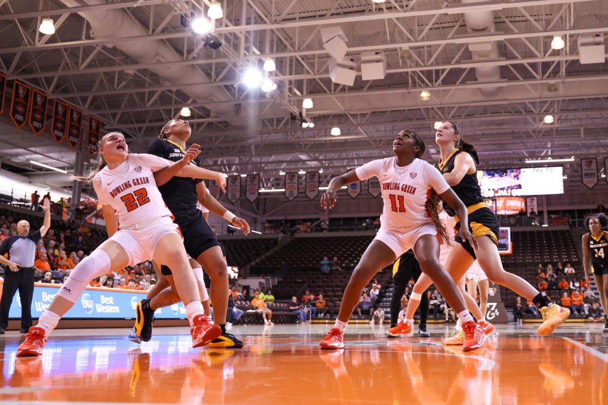 Bowling Green, OH - Falcons freshman forward Lauren Gerken (22) and sophomore forward Taya Ellis (11) box out some Golden Eagles at the Stroh Center in Bowling Green, Ohio.