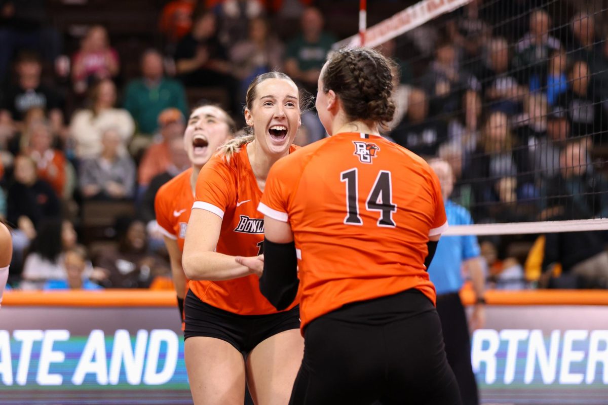 Bowling Green, OH - Fa;cpms fifth year middle blocker Alexis Mettille (16) celebrates with junior opposite Lauryn Hovey (14) after an amazing play against the Ohio Bobcats at the Stroh Center in Bowling Green, Ohio.