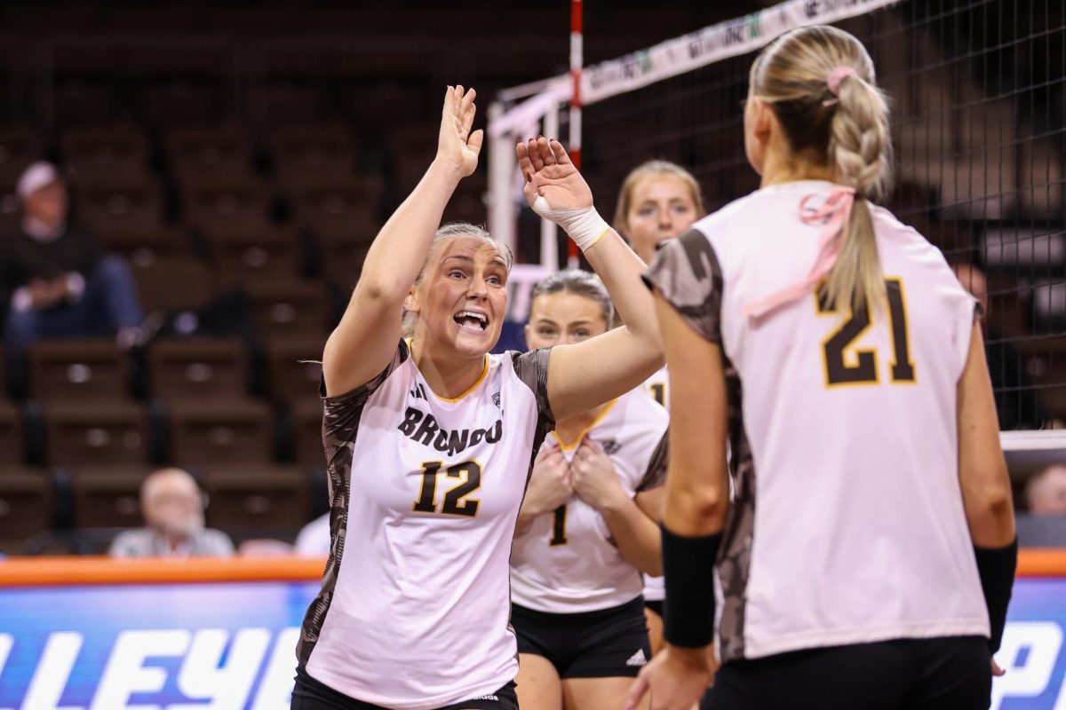 Bowling Green, OH - Broncos fifth year setter Logan Case (12) celebrates after scoring a crucial point against the Buffalo Bulls at the Stroh Center in Bowling Green, Ohio.