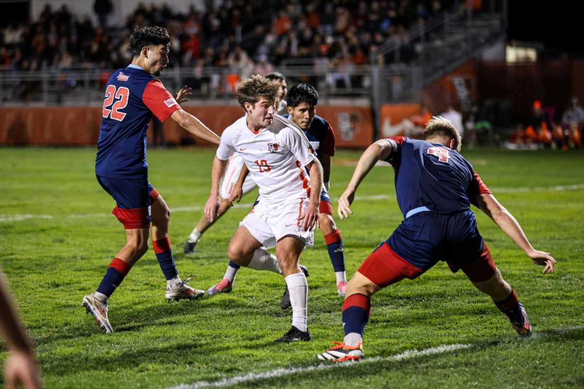 Bowling Green, OH - Falcons midfield freshman Ryko Bodurov (19) looks back as his kick sends the ball creeping into the goal against the Flames at Cochrane Stadium in Bowling Green, Ohio.