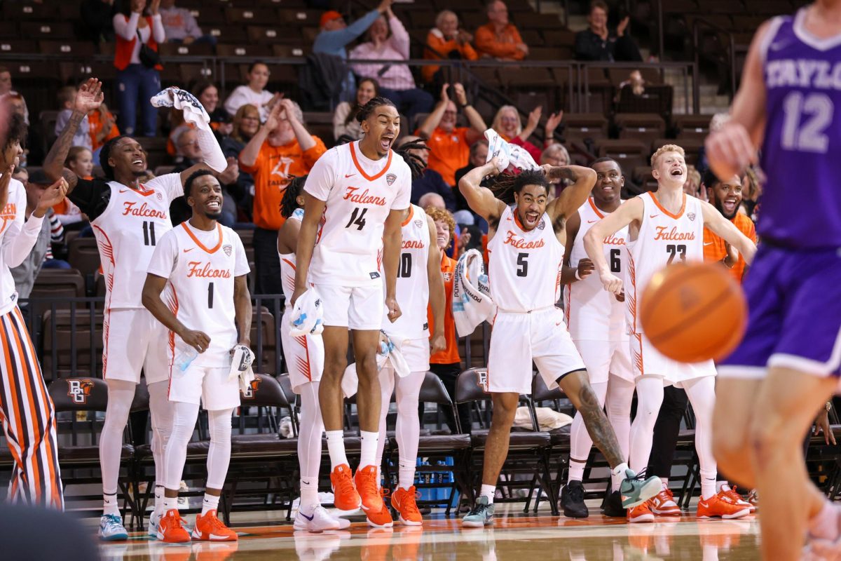 Bowling Green, OH - The Falcons bench reacts to freshman guard Jaxon Pardon's (0) second only collegiate basket, a dunk, against Taylor University at the Stroh Center in Bowling Green, Ohio.