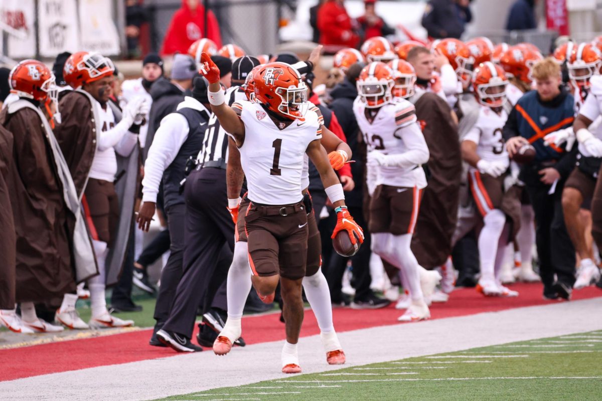 Muncie, IN - Falcons senior cornerback Jordan Oladokun (1) runs along the sideline in celebration after tallying an interception against the Cardinals at Scheumann Stadium in Muncie, Indiana.